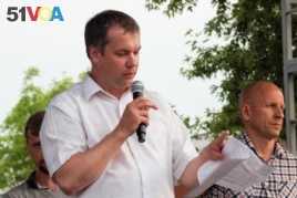 FILE - Anatoly Bokun, leader of strike committee at Belaruskali, a huge potash factory in Soligorsk, speaks to workers in Soligorsk, Belarus, Wednesday, Aug. 19, 2020.