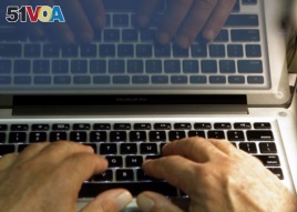 FILE - In this Feb. 27, 2013, file photo illustration, hands type on a computer keyboard in Los Angeles.