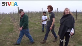 Virginia winery owner Doug Fabbioli walks with farming students at his free agriculture school. 