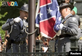 The Confederate battle flag is permanently removed from the South Carolina statehouse grounds during a ceremony in Columbia, South Carolina July, 10, 2015. 