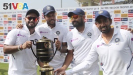 From left, India's Rishabh Pant, Umesh Yadav, Mohammed Shami and Wriddhiman Saha pose with the winners trophy after their win on the fourth day of third and last cricket test match between India and South Africa in Ranchi, India, Tuesday, Oct. 22, 2019. I