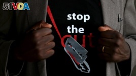 FILE - A T-shirt warns against female genital mutilation. Its wearer attends an event, discouraging harmful practices such as FGM, at a girls high school in Imbirikani, Kenya, April 21, 2016. (REUTERS/Siegfried Modola)