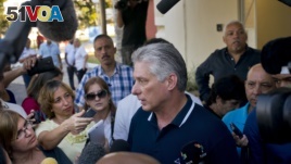 Cuba's President Miguel Diaz-Canel talks to the press after voting in a referendum to approve or reject the new constitution in Havana, Cuba, Sunday, Feb. 24, 2019. 
