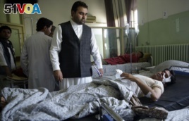 Wounded men lie on their beds in Wazir Akbar Khan Hospital in Kabul after a massive explosion.