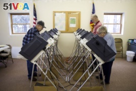 Voters cast their ballots in the primary election Tuesday, March 15, 2016, in Chesterville, Ohio. Voters in five states are making their choices in party primaries. (AP Photo/Matt Rourke)