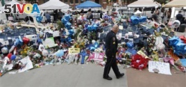 An officer looks at memorial for killed Dallas officers.
