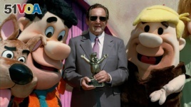 Joseph Barbera poses with famed Hanna-Barbera cartoon characters, from left, Scooby Doo, Fred Flintstone and Barney Rubble