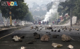 Rocks are scattered on a road, placed there by protesters, in Tegucigalpa, Honduras, Friday, Dec. 15, 2017.