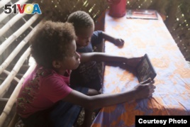 Students in Vanuatu use the SolarSPELL offline library (Photograph courtesy of Dr. Laura Hosman)