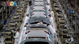 Employees work on a production line inside a Dongfeng Honda factory after lockdown measures in Wuhan were further eased, April 8, 2020. (REUTERS/Aly Song)