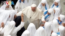 Pope Francis is greeted by a group of nuns during his weekly general audience in the Pope Paul VI hall at the Vatican, Wednesday, Aug. 22, 2018. (AP Photo/Andrew Medichini)