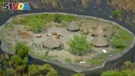 FILE - Thatched huts surrounded by floodwaters are seen from the air in Old Fangak county in Jonglei state, South Sudan on Nov. 27, 2020. The people of South Sudan are debating whether to restart the canal project. (AP Photo/Maura Ajak, File)