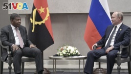 FILE - Angola's President Joao Lourenco, left, speaks to Russia's President Vladimir Putin at the BRICS summit in Johannesburg, South Africa, July 26, 2018. With its summit meeting in Sochi, Russia hopes to build economic, security ties. 