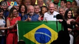 Luiz Inacio Lula da Silva (center) celebrates after winning the presidential run-off election, in Sao Paulo, Brazil, on October 30, 2022. (Photo by NELSON ALMEIDA / AFP)