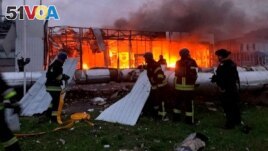Firefighters work at the site of a car retailer office building, destroyed during a Russian missile attack in Zaporizhzhia, Ukraine Oct. 11, 2022. (Handout photo/Press service of the State Emergency Service of Ukraine)