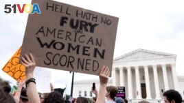 FILE - People protest at the Supreme Court following the high court's decision to overturn Roe v. Wade in Washington, June 24, 2022.
