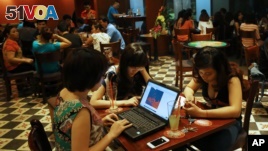 Three young Vietnamese girls go online at a cafe in Hanoi, Vietnam, May 14, 2013. The country's potential for growth, young population and good Internet infrastructure have made it an attractive destination for regional and international investors and startups.