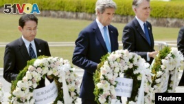 U.S. Secretary of State John Kerry (center) prepares to lay a wreath with Japan's Foreign Minister Fumio Kishida (L), Britain's Foreign Minister Philip Hammond at Hiroshima Peace Memorial Park during the G-7 ministers' meeting.