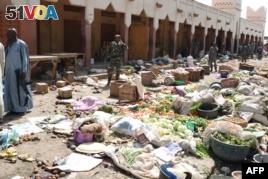 Soldiers guard a market in N'Djamena following a suicide bomb attack on July 11, 2015. 