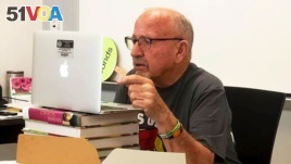 In this photo provided by Farmington Municipal Schools, Gerald Bonds, 86, speaks with an AP reporter via video chat at Farmington High School on Sept. 14, 2020, in Farmington, N.M. (Farmington Municipal Schools via AP)