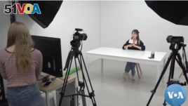Kang Nara prepares to film a YouTube video from her Seoul studio (video screengrab via VOA News)