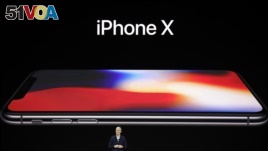 Apple CEO Tim Cook announces the new iPhone X at the Steve Jobs Theater on the new Apple campus, Tuesday, Sept. 12, 2017, in Cupertino, Calif. (AP Photo/Marcio Jose Sanchez)