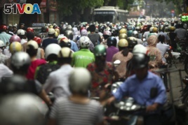 n this photo taken Monday, May 21, 2012, motorcyclists drive in rush hour on La Thanh street which is one of the worst traffic jam roads, in Hanoi, Vietnam.
