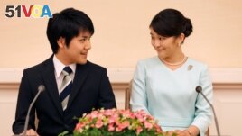 Princess Mako, the elder daughter of Prince Akishino and Princess Kiko, and her fiancee Kei Komuro, a university friend of Princess Mako, smile during a press conference to announce their engagement at Akasaka East Residence in Tokyo, Japan, Sept. 3, 2017