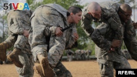 Then U.S. Army First Lieutenant Kirsten Griest (C) and fellow soldiers participate in combatives training during the Ranger Course on Fort Benning, Georgia.