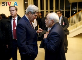 U.S. Secretary of State John Kerry talks with Iranian Foreign Minister Javad Zarif after the International Atomic Energy Agency (IAEA) verified that Iran has met all conditions under the nuclear deal, in Vienna January 16, 2016.