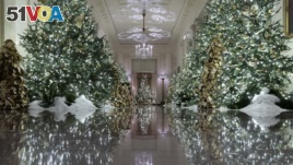 The Cross Hall leading into the State Dinning Room is decorated during the 2019 Christmas preview at the White House, Monday, Dec. 2, 2019, in Washington.