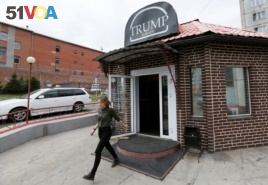 A visitor walks out of Trump Burger, a new Russian diner named after U.S. President Donald Trump, with a detention centre seen in the background, in Krasnoyarsk, Russia July 17, 2018.
