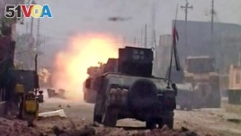 This image made from Associated Press video shows a tank during clashes in Fallujah, June 26, 2016.