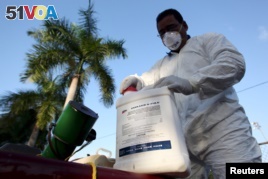 FILE - A health worker prepares insecticide before fumigating a neighborhood in San Juan, Puerto Rico, Jan. 27, 2016. On Friday, an elderly man on the U.S. territory became the first victim of the Zika virus on U.S. soil.