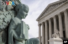 A cherub holding an open book adorns a flagpole on the plaza of the Supreme Court in Washington, Monday, April 4, 2016. The justices ruled in a case involving the constitutional principle of 