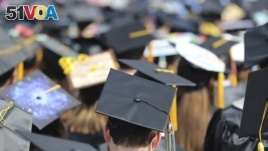 FILE - In this May 5, 2018, file photo, graduates at the University of Toledo commencement ceremony in Toledo, Ohio. Colleges across the U.S. have begun cancelling and curtailing spring graduation events amid fears from the coronavirus. 