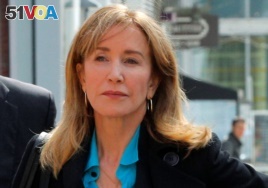 Actor Felicity Huffman, facing charges in a nationwide college admissions cheating scheme, enters federal court in Boston, Massachusetts, April 3, 2019.
