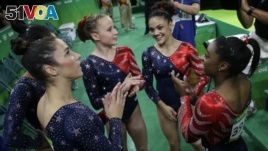 U.S. gymnasts, from left, Aly Raisman, Gabby Douglas, Madison Kocian, Lauren Hernandez and Simone Biles wait for the score during the artistic gymnastics women's qualification at the 2016 Summer Olympics in Rio de Janeiro, Brazil, Aug. 7, 2016. 
