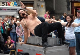 Magician Timothy Terror gets off a bed of nails as he performs on the first day of the Edinburgh Fringe Festival, Aug 2010. (AP /Scott Campbell)