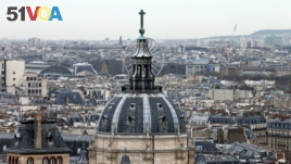 FILE- A city view shows the dome at La Sorbonne University as part of the skyline in Paris, France, March 30, 2016. 