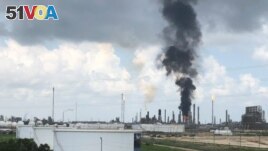 FILE - Smoke rises from a fire at Exxon Mobil's refining and chemical plant complex in Baytown, near Houston, Texas, July 31, 2019. 