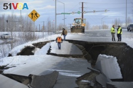 Workers inspect an off-ramp that collapsed during a morning earthquake, Nov. 30, 2018, in Anchorage, Alaska.