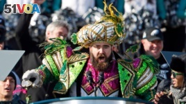 In this Feb. 8, 2018, file photo, Philadelphia Eagles center Jason Kelce, wearing a Mummers costume, speaks at the conclusion of the NFL team's Super Bowl victory parade in front of the Philadelphia Museum of Art in Philadelphia. (AP Photo/Alex Brandon)