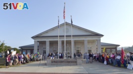 A gathering of same sex marriage supporters, left, and supporters of Rowan County Clerk Kim Davis, right, face off in front of the Rowan County Courthouse in Morehead, Ky., Sept. 1, 2015.