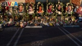 FILE - Messages are written at a memorial outside Star Dance Studio in Monterey Park, California, Thursday, January 26, 2023. The U.S. is setting a record pace for mass killings in 2023. (AP Photo/Jae C. Hong, File)