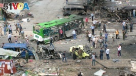  In this photo released by the Syrian official news agency SANA, Syrians inspect damages after a bombing attack at a bus station, in the coastal town of Tartus, Syria, Monday, May 23, 2016. 