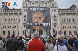 FILE: A man holds a poster of Hungarian Premier Viktor Orban that reads 