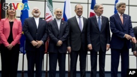 From left to right: European Union High Representative Federica Mogherini, Iranian Foreign Minister Mohammad Javad Zarif, Head of the Iranian Atomic Energy Organization Ali Akbar Salehi, Russian Foreign Minister Sergey Lavrov, British Foreign Secretary Philip Hammond and US Secretary of State John Kerry pose for a group picture at the United Nations building in Vienna, Austria, Tuesday, July 14, 2015. (Joe Klamar/Pool Photo via AP)