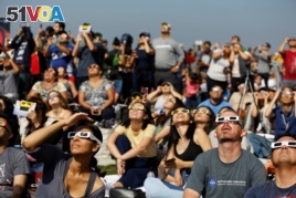People watch the solar eclipse on the lawn of Griffith Observatory in Los Angeles, California, U.S., August 21, 2017.