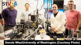 This instrument built by UW engineers (from left) Peter Pauzauskie, Xuezhe Zhou, Bennett Smith, Matthew Crane and Paden Roder (unpictured) used infrared laser light to refrigerate liquids for the first time.Dennis Wise/University of Washington